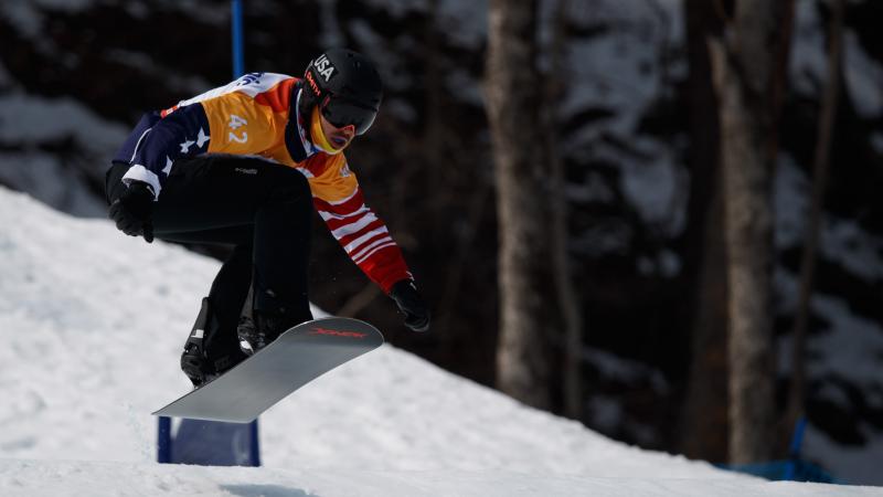 A male Para snowboarder competing 