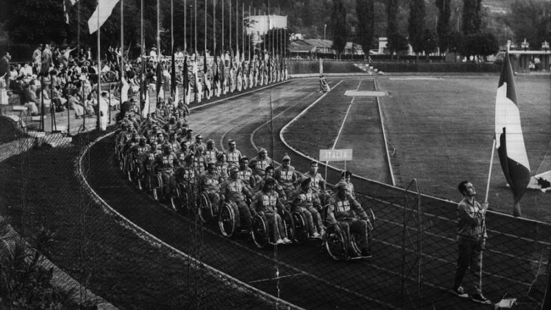 Old black and white photo of Italy marching into the stadium