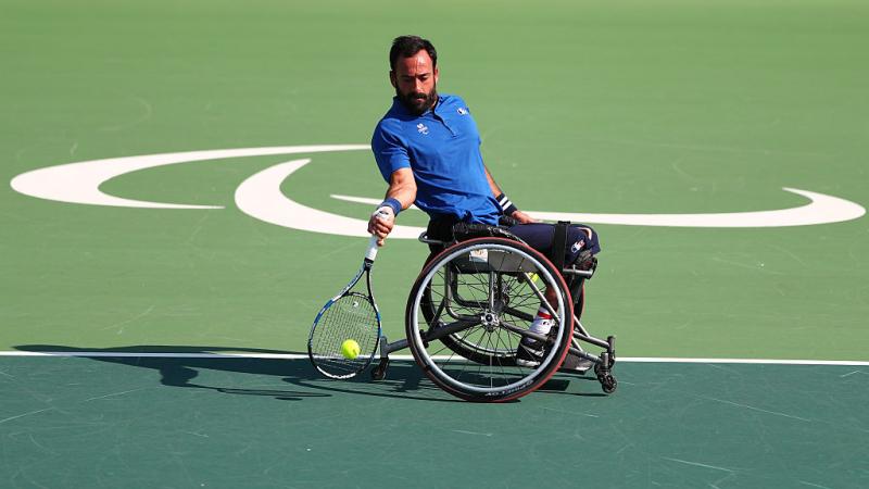 French man in wheelchair returns tennis shot