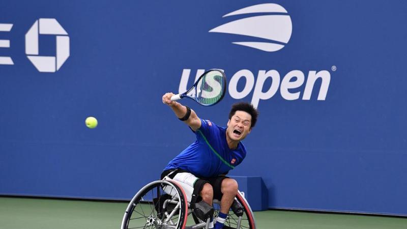 Japanese male wheelchair tennis player returns a shot