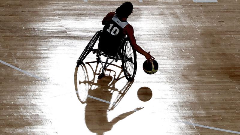 Female wheelchair basketball player dribble the ball