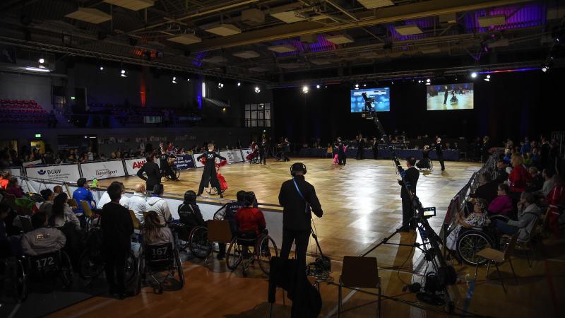 An external view of a Para dance sport venue with five couples competing