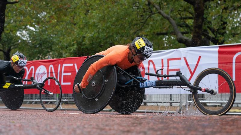A female wheelchair racer ahead of another female wheelchair racer in the London Marathon