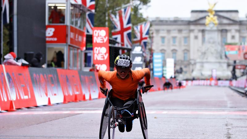 A female wheelchair racer crossing the line in the streets of London