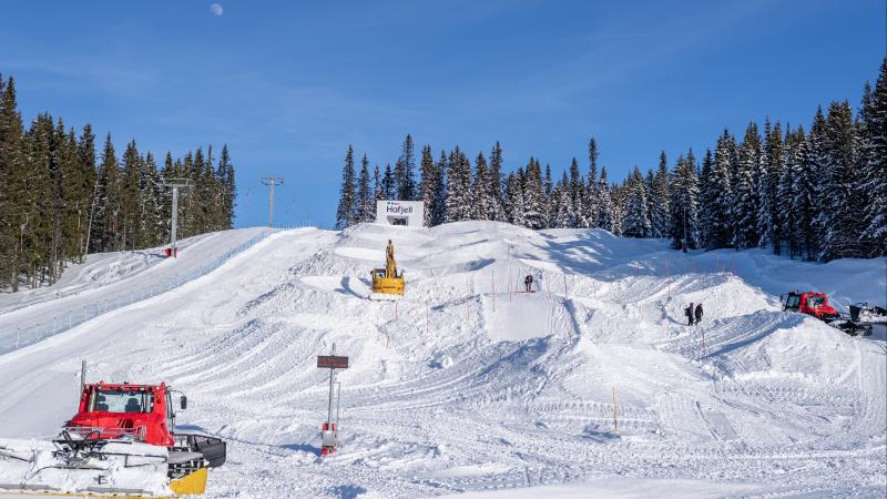 Three snowcats moving the snow to build a Para snowboard course