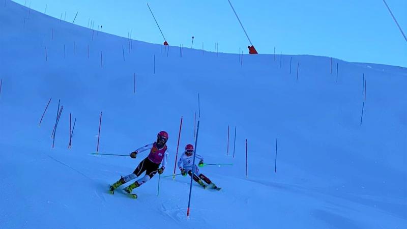 A vision impaired Para alpine skier following the guide in a slalom competition