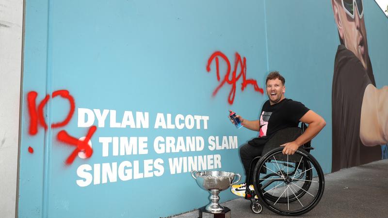 Male wheelchair tennis player next to wall art