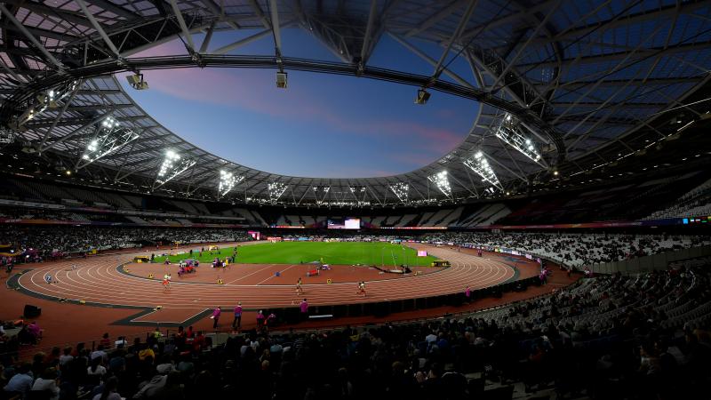 A general view of the London Stadium showing the stands, the athletics track with athletes competing