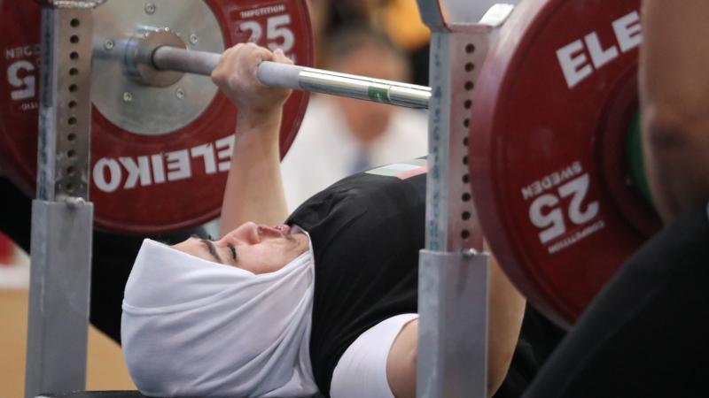 Female UAE powerlifter about to push the bar