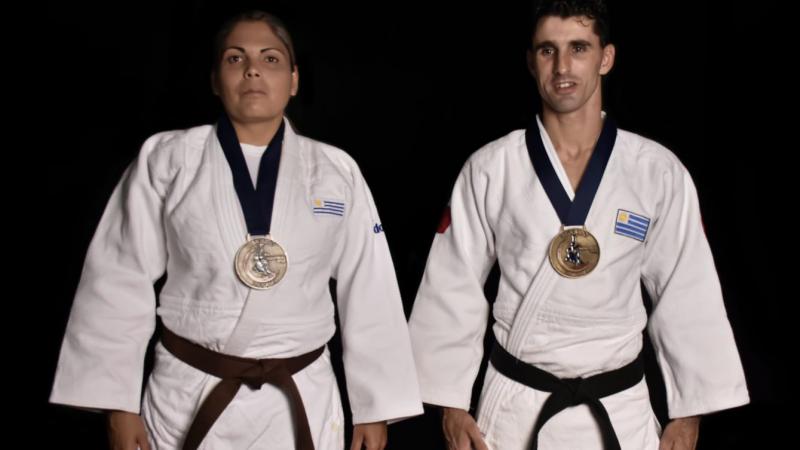 Henry Borges and Mariana Mederos standing with the Lima 2019 medals hanging on their necks
