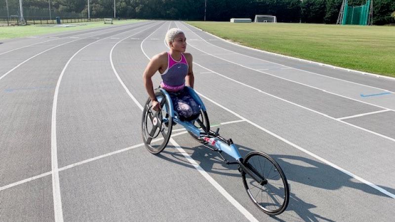 Black female wheelchair racer in her racing chair on the track