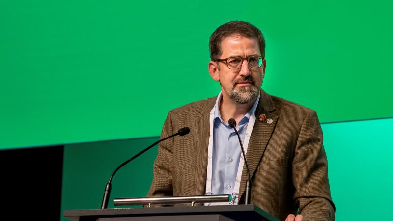 Man speaking on a podium