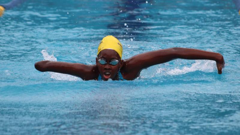 Black female swimmer with missing forearm swimming