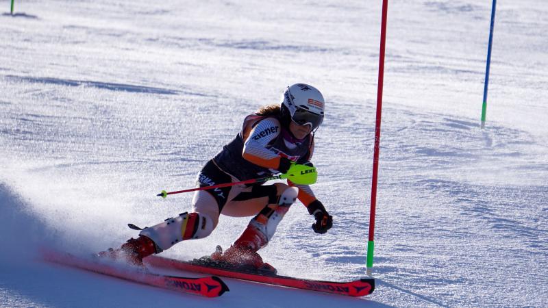 A woman competing in an alpine skiing slalom competition 