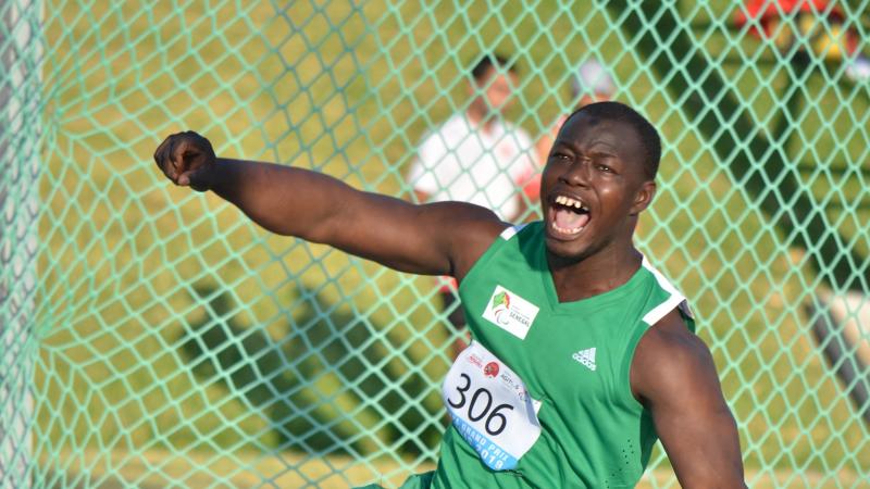 Black man yells after releasing discus