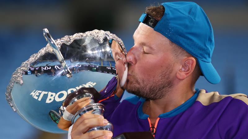 Dylan Alcott kisses Australian Open trophy