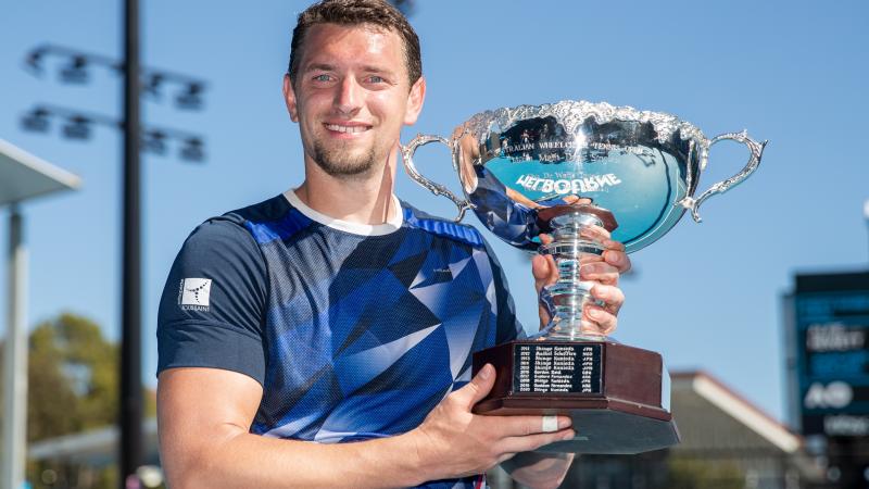 Joachim Gerard poses with the Australian Open trophy