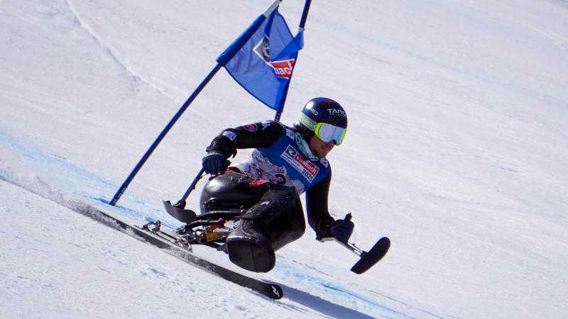 Male sit-skier makes a turn