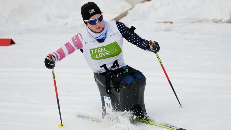 A female sit-skier in a cross-country competition 