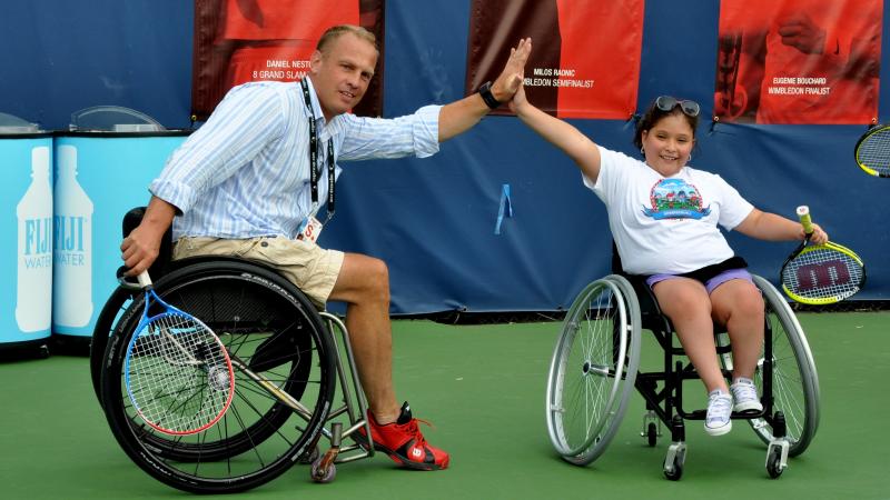 Kai Schrameyer high-fives a kid