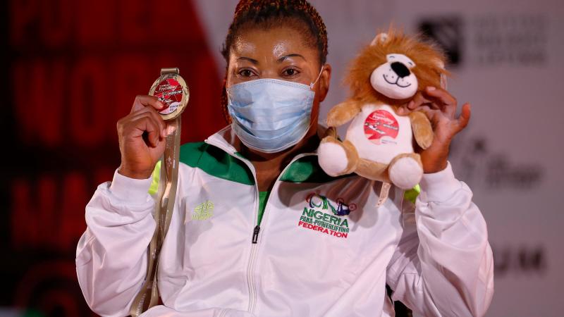 Lucy Ejike poses with her gold medal after winning in Manchester