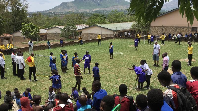 Crowd of people watching a blind football game