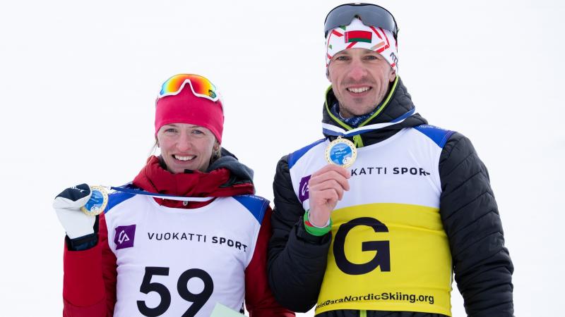 Belarus’ Sviatlana Sakhanenka and her guide Dzmitry Budzilovich at the podium at Vuokatti 2021 World Cup