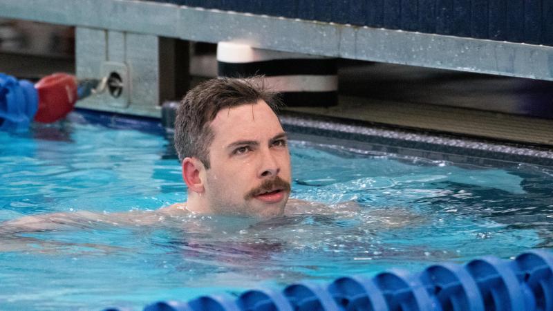A male swimmer with a moustache in the swimming pool