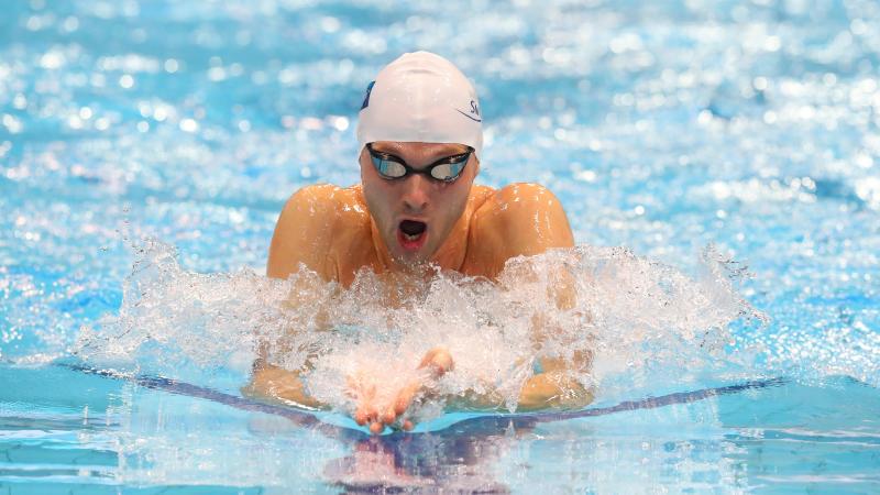 A man swimming breaststroke in a swimming pool