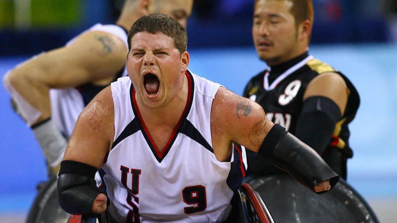 Male wheelchair rugby player celebrating 