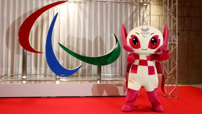 Tokyo 2020 mascot Someity standing in front of Agitos