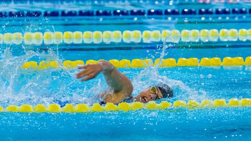A woman swimming in a Para swimming competition