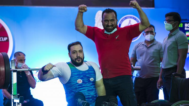 Roohallah Rostami celebrates with his coach