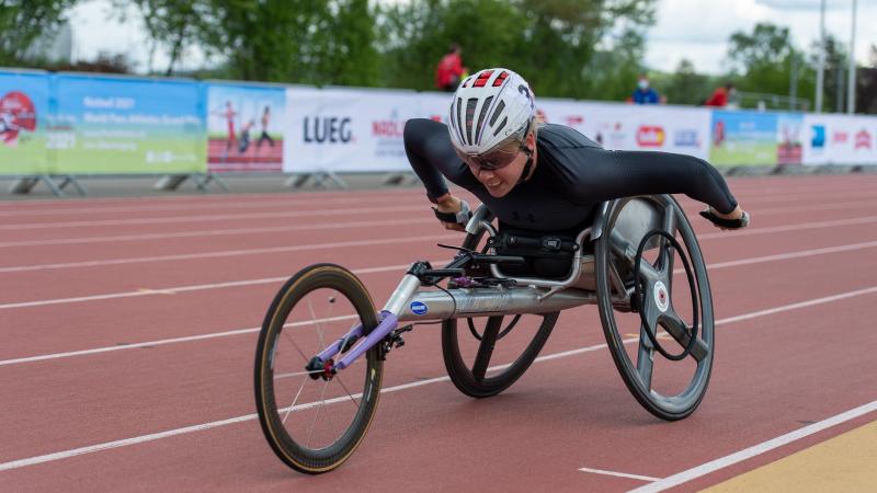 A woman in a racing wheelchair during a Para athletics race