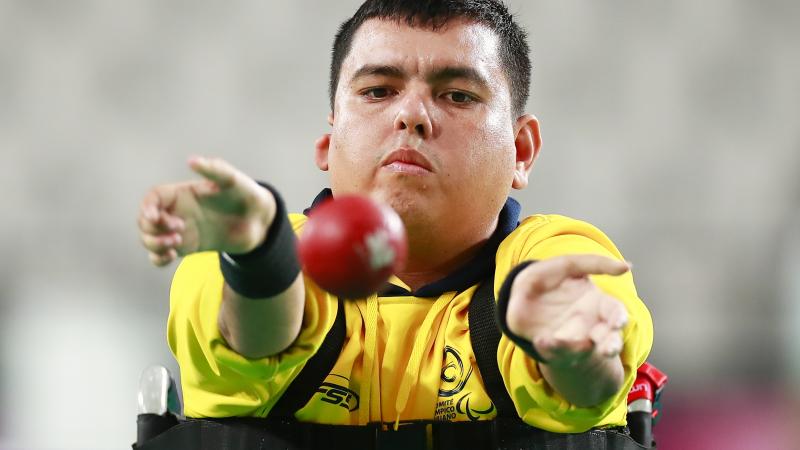 Colombia male boccia player throws the ball