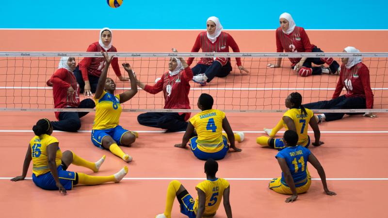 Rwandan and Iranian women's sitting volleyball teams competing
