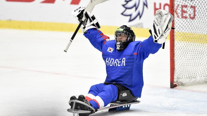 A Korean Para ice hockey goaltender celebrating on ice