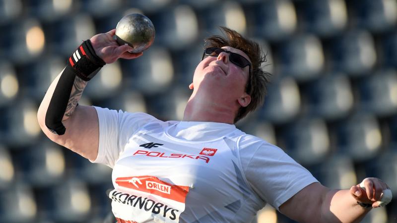 A woman competing in shot put 