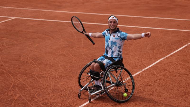 Alfie Hewett smiles and opens his arms in celebration