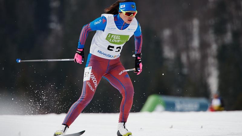 A female cross-country skier in competition