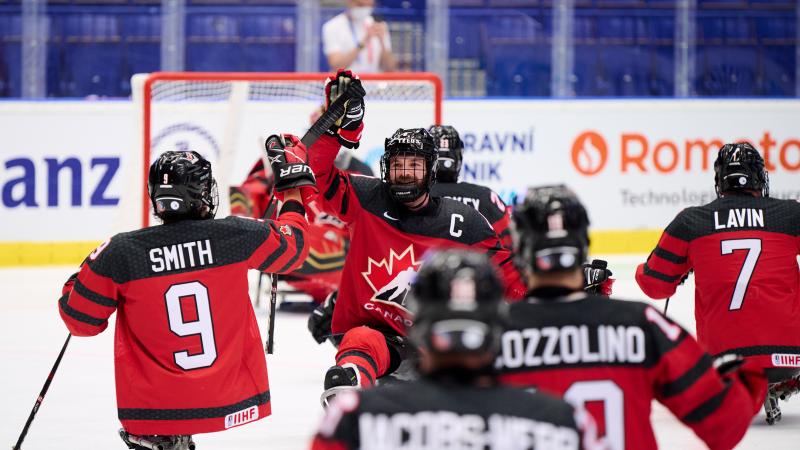 A group of Canadian Para ice hockey players celebrating