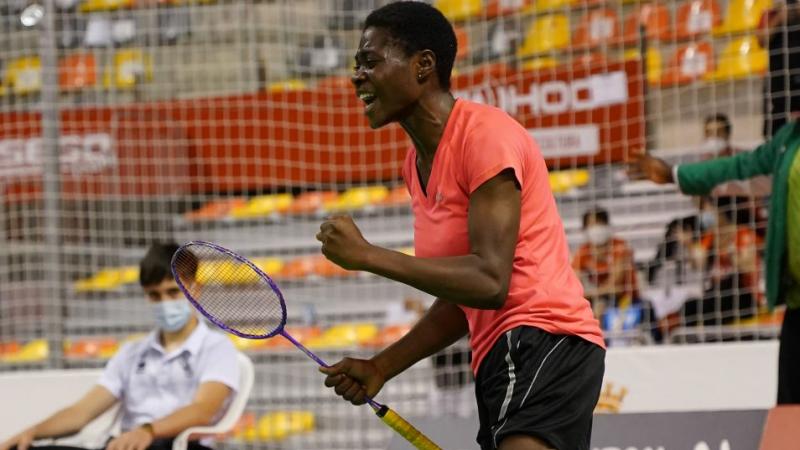 Nigerian Para badminton player Mariam Eniolo Bolaji celebrates with a clinched fist and a scream while holding her racket