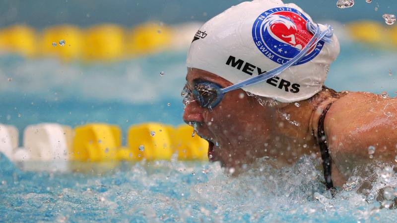 A woman putting her head out of the water during a swimming competition