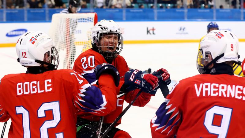 Three Norwegian Para ice hockey players celebrating on ice