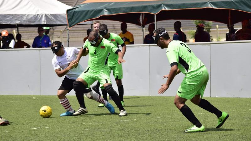 Moroccan and Egyptian football 5-a-side players fighting for the ball