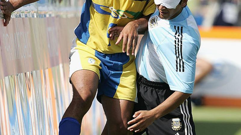 Two blind footballers battle for the ball