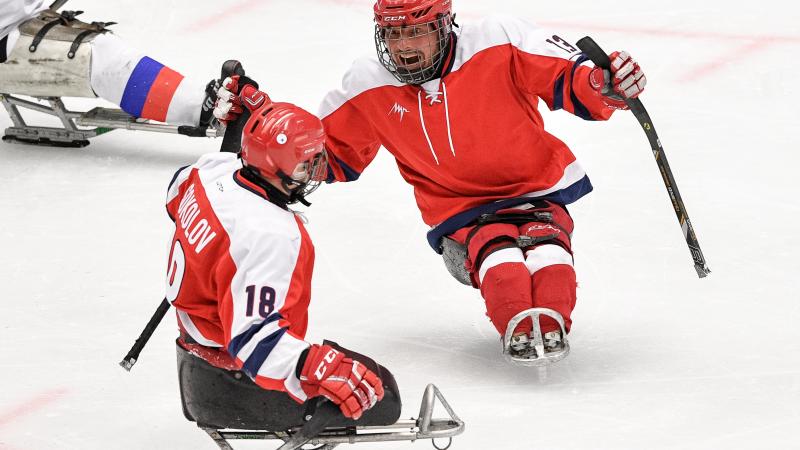 Two Para ice hockey players celebrating on ice