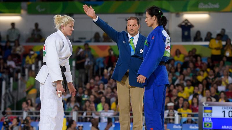 Two female judoka face each other before competing