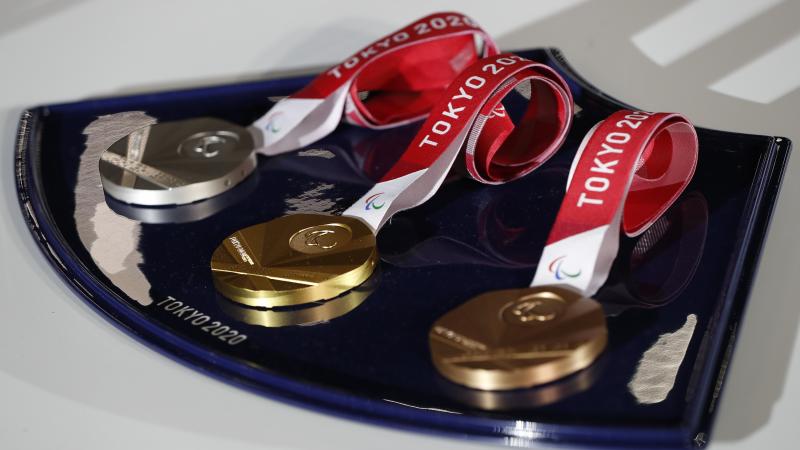 Tokyo 2020 gold, silver and bronze Paralympic medals being displayed one next to the other