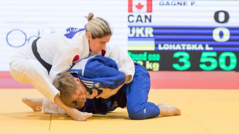 Judoka holds another on the floor